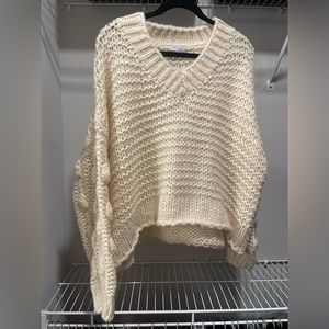 cropped oversized cream knit sweater with large polka-dot detailing